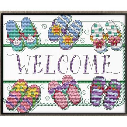 A cross stitched welcome sign

Description automatically generated